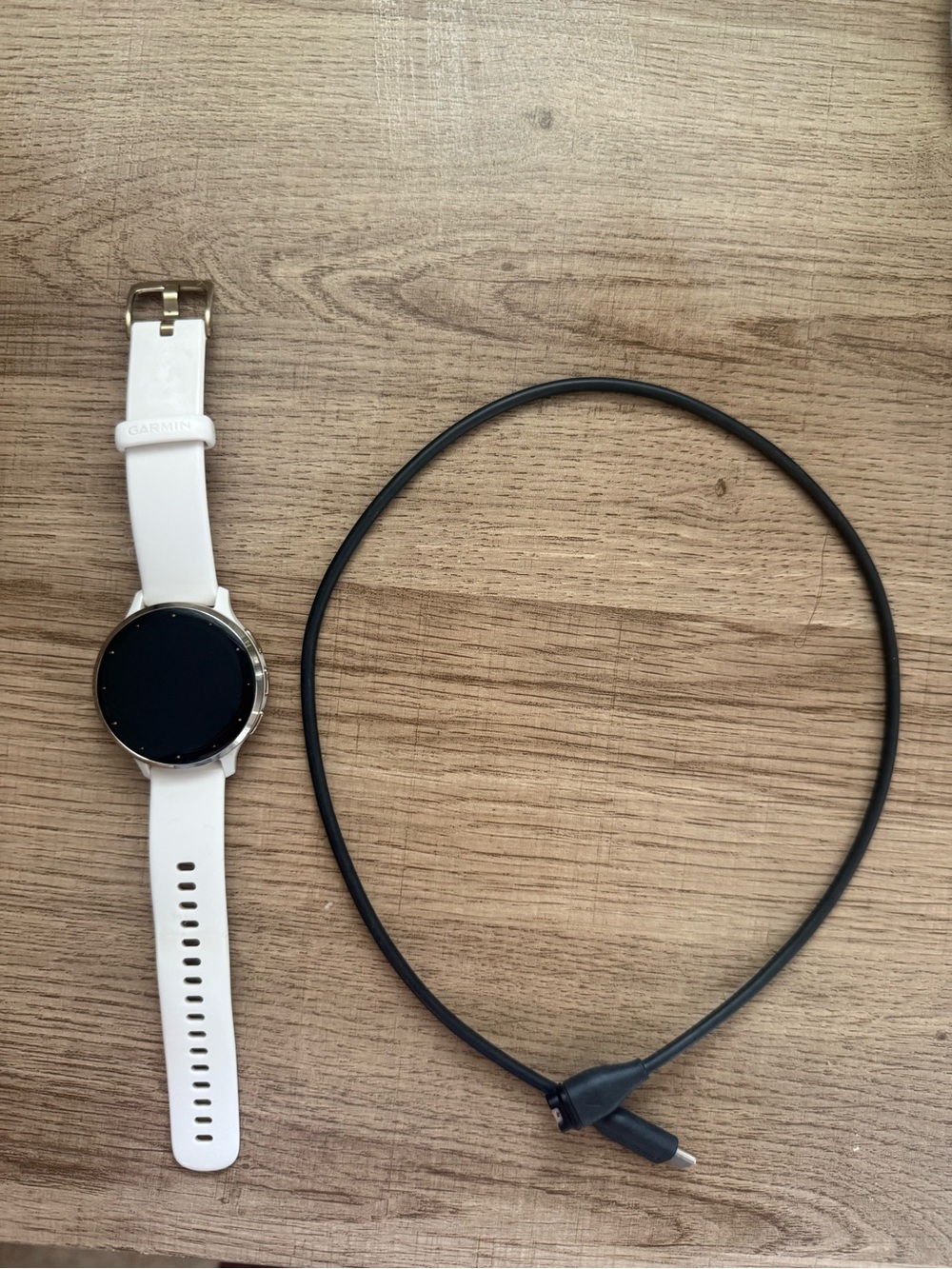 garmin smartwatch with white band and silver bezel